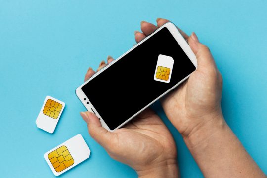 front-view-hands-holding-smartphone-sim-cards